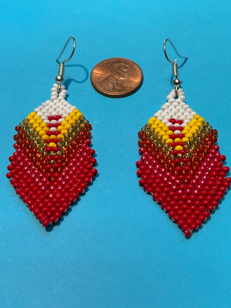 Guatemalan handcrafted glass seed beads in earrings in a feather design.