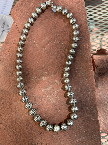 Navajo Pearl style sterling silver necklace with stamped arrow design in a 18.5”  length with three different bead sizes.  By A.S.   AS612