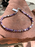 Purple Jasper 8mm round beads in a 17” length with sterling silver. JK25