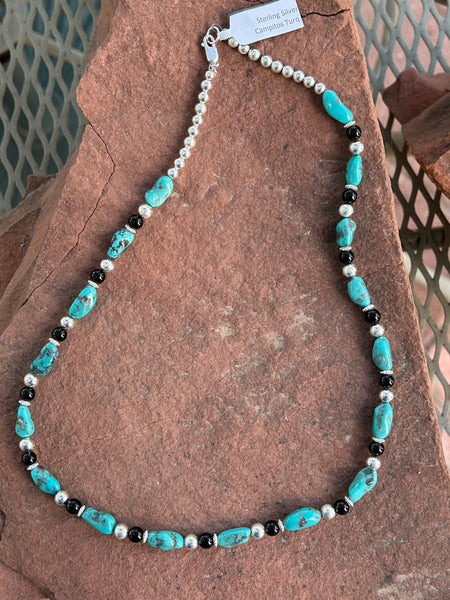 Genuine Campitos Turquoise with black onyx and sterling silver beads in a 22” length.  SR120