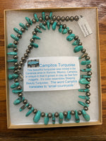 Genuine and natural color Campitos turquoise teardrop necklace with etched Aztec design sterling silver beads and lobster claw clasp. 25”.  A.S.    CAMP-2 FREE SHIPPING IN THE CONTINENTAL USA.