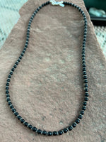 Black Onyx in a flat, non shiny finish, 4mm, with sterling silver, 20.5” long. SR1018