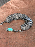 Navajo handcrafted silver Mercury dime bracelet with turquoise stone.  LZ044