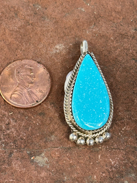 Navajo handcrafted sterling silver, genuine turquoise pendant, 1.5” top to bottom.  LZ075