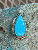 Navajo handcrafted sterling silver, genuine turquoise pendant, 1.5” top to bottom.  LZ075