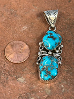 Navajo handcrafted sterling silver, genuine turquoise, pendant, 2.25” top to bottom.  LZ080