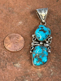 Navajo handcrafted sterling silver, genuine turquoise, pendant, 2.25” top to bottom.  LZ080
