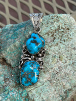 Navajo handcrafted sterling silver, genuine turquoise, pendant, 2.25” top to bottom.  LZ080