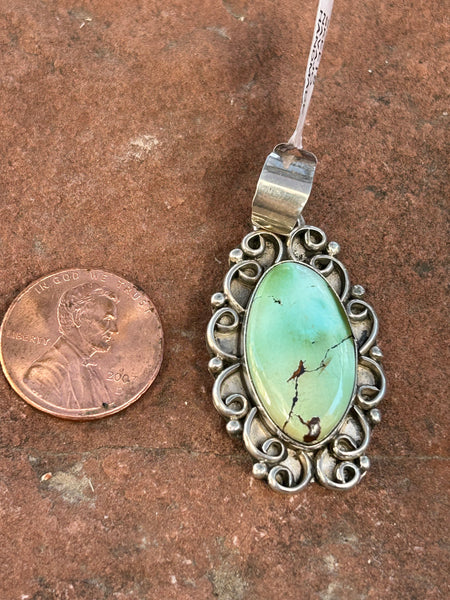 Navajo handcrafted sterling silver and genuine turquoise, pendant, 1.65” top to bottom.  LZ081