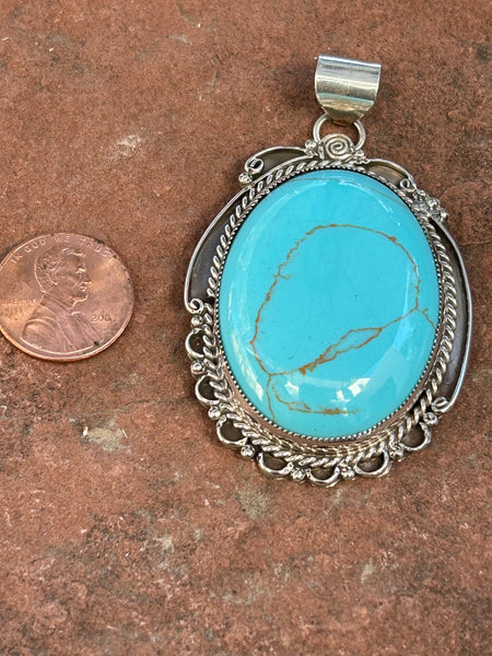 Navajo handcrafted sterling silver, genuine turquoise, 2.50” top to bottom. LZ083