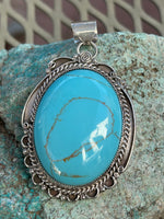 Navajo handcrafted sterling silver, genuine turquoise, 2.50” top to bottom. LZ083