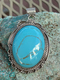 Navajo handcrafted sterling silver, genuine turquoise, 2.50” top to bottom. LZ083