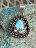 Navajo Handcrafted sterling silver with genuine turquoise, 1.75” top to bottom, LZ087