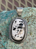 Navajo handcrafted sterling silver with White Buffalo Stone, 2” top to bottom, LZ089