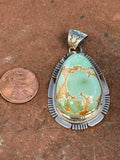Navajo Handcrafted sterling silver, genuine turquoise, 2.25” top to bottom, LZ090