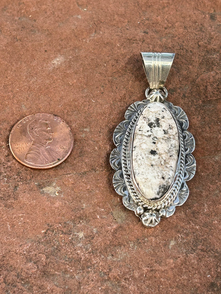 Navajo handcrafted sterling silver and White Buffalo Stone, 2.5” top to bottom. LZ091B