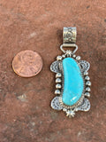 Navajo handcrafted sterling silver and genuine turquoise pendant 2.25” top to bottom.  LZ099