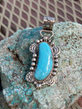 Navajo handcrafted sterling silver and genuine turquoise pendant 2.25” top to bottom.  LZ099