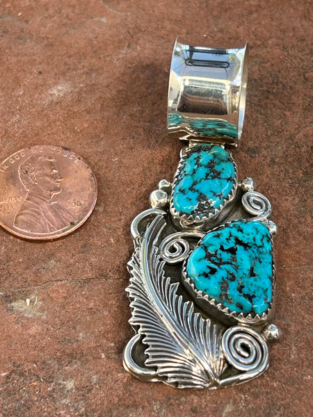 Navajo handcrafted sterling silver and genuine turquoise pendant, 2.5” top to bottom.  LZ102