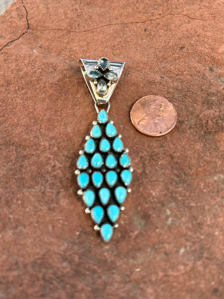Navajo handcrafted sterling silver with genuine turquoise and faceted Iolite. 3” top to bottom.  LZ107