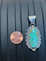 Navajo Handcrafted sterling silver pendant with genuine Turquoise stone.  LZ292