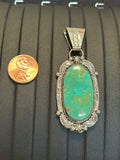 Navajo handcrafted sterling silver pendant with genuine turquoise stone.  LZ298