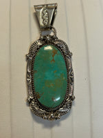Navajo handcrafted sterling silver pendant with genuine turquoise stone.  LZ298