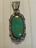 Navajo handcrafted sterling silver pendant with genuine turquoise stone.  LZ298