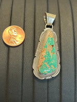 Navajo handcrafted sterling silver pendant with genuine turquoise. LZ301