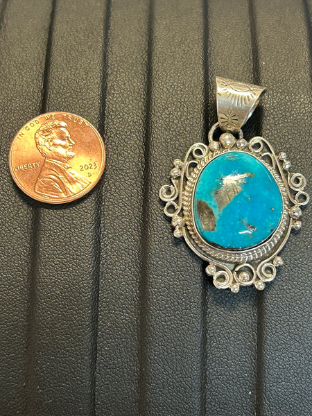 Navajo handcrafted sterling silver pendant with genuine turquoise stone.  LZ302