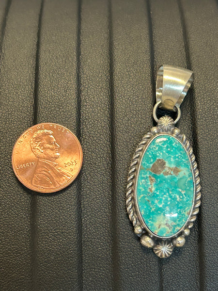 Navajo handcrafted sterling silver pendant with genuine turquoise stone.  LZ303