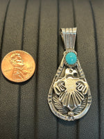 Navajo handcrafted sterling silver pendant with genuine turquoise stone.  LZ306