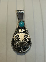 Navajo handcrafted sterling silver pendant with genuine turquoise stone.  LZ306