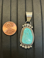 Navajo handcrafted sterling silver pendant with genuine turquoise stone.  LZ308