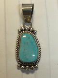 Navajo handcrafted sterling silver pendant with genuine turquoise stone.  LZ308