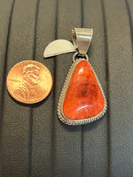 Navajo Handcrafted sterling silver pendant with Spiney Oyster shell stone.  LZ312
