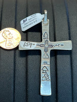 Navajo Handcrafted sterling silver with genuine turquoise stones in a cross.  2 sided.  LZ321