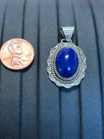 Navajo handcrafted sterling silver pendant with genuine Lapis stone.  LZ340