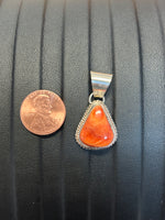 Navajo handcrafted sterling silver pendant with genuine Spiney Oyster shell stone.  LZ347