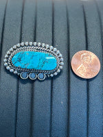 Navajo handcrafted sterling silver brooch with genuine turquoise stone.  LZ372