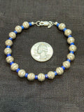 Genuine Lapis stone with sterling silver beads in a bracelet.  7.5” long.  SR1075