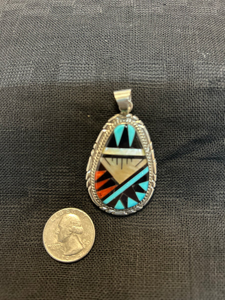 Zuni handcrafted sterling silver pendant with genuine stone inlay.  LZ483