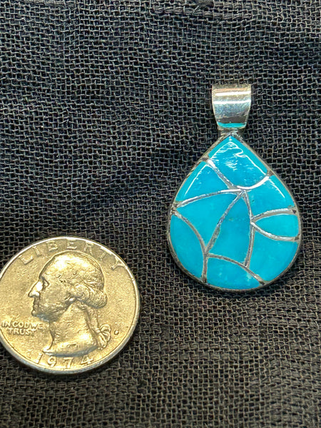 Zuni handcrafted sterling silver pendant with genuine turquoise inlay. LZ511