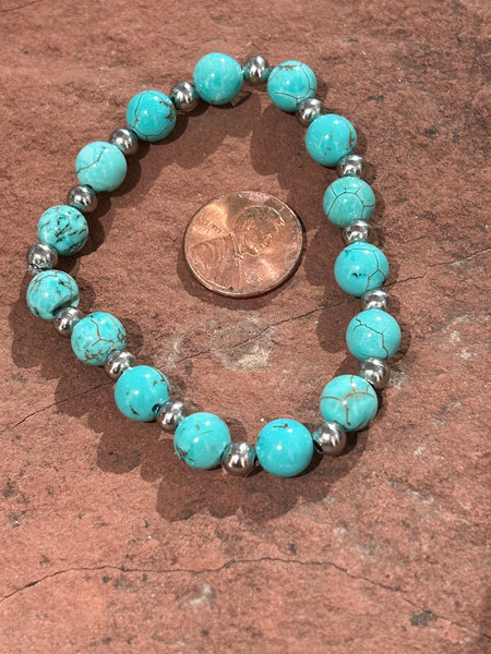 Genuine Turquoise and Howlite stone beads in an Elastic bracelet.  Stretch to fit.  SR1091
