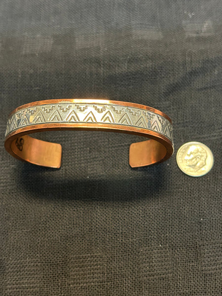 Navajo handcrafted solid copper with sterling silver accent.  LZ588