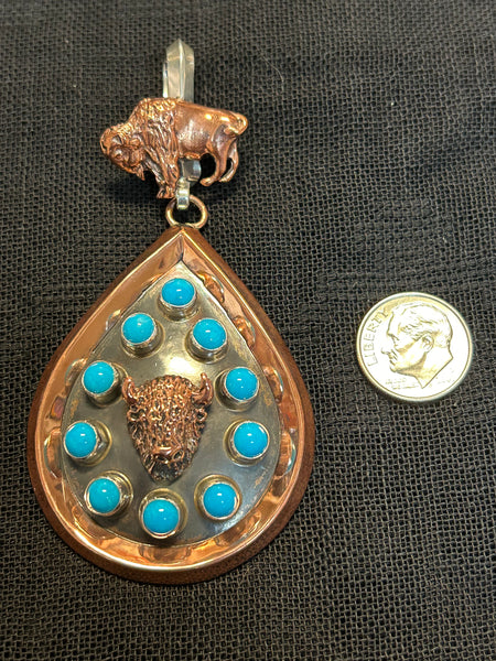 Navajo handcrafted solid copper pendant with genuine turquoise and sterling silver.  LZ610