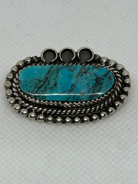 Navajo handcrafted sterling silver brooch with genuine turquoise stone.  LZ372