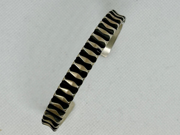 Navajo handcrafted sterling silver bracelet by Leander Tahe.  LZ802