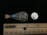 Navajo handcrafted sterling silver pendant with genuine turquoise stone.  LZ306