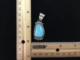 Navajo handcrafted sterling silver pendant with genuine turquoise stone.  LZ308
